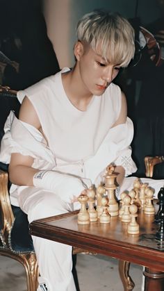 a person sitting at a table playing chess