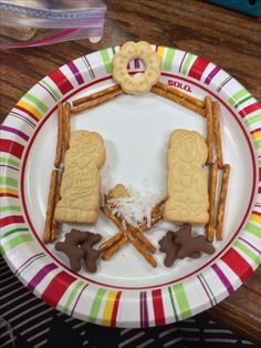 a plate with cookies and pretzels on it