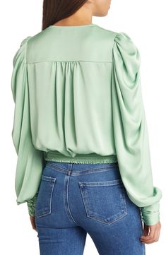 A serene shade and a lustrous fabric softly animate this graceful blouse styled with the season's abundant sleeves. 20" length (size medium) 100% polyester Dry clean Imported Elegant Green Top With Gathered Sleeves, Green Fitted Top With Gathered Sleeves, Chic Green Top With Gathered Sleeves, Chic Green Tops With Gathered Sleeves, Elegant Flowy Green Blouse, Green V-neck Blouse With Blouson Sleeves, Green V-neck Tops With Blouson Sleeves, Elegant Green Flowy Top, Elegant Flowy Green Top