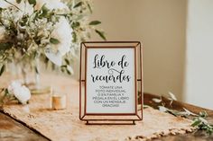 a wooden table topped with flowers and a sign that says libor de regentes