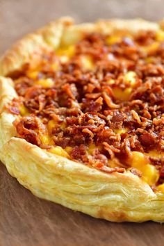 a close up of a pizza on a wooden table