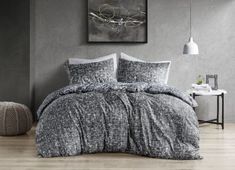 the comforter is made up with black and white linens, while the bedding is