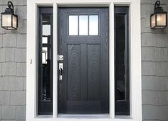 a black front door with two lights on the side