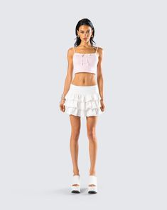 Exude a fresh and playful vibe in this simple two-piece set 🎀 Pairing a cutesy pink bow cami top with an ivory ruffle micro mini skirt, this fit is the perfect everyday summer time look 🤍 Pink Flirty Crop Top With Ruffles, Flirty Mini Skirt For Summer Day Out, Flirty Pink Ruffled Crop Top, Pink Flirty Crop Top For Summer, Cute Beach Mini Skirt For Summer, Pink Mini Skirt For Summer Brunch, Feminine Ruffled Crop Top For Day Out, Feminine Ruffled Mini Skirt For The Beach, Feminine Ruffled Mini Skirt For Beach