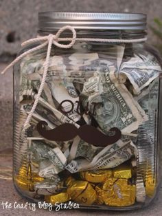 a mason jar filled with money and a mustache