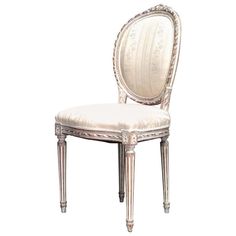 an antique style chair with white upholstered back and arm rests against a white background