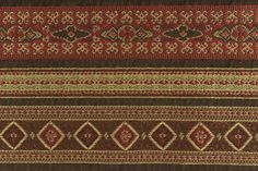 a brown and red rug with many different designs