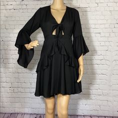 Black Dress With Ruffle Details. Tie Front At Chest. Hidden Zipper In Back. 3/4 Bell Sleeves. Only One Available. Black Mini Dress With 3/4 Sleeves For Summer, Black Bell Sleeve Dresses For Spring, Casual Black Bell Sleeve Dress, Casual Black Dress With Bell Sleeves, Chic Mini Dress With 3/4 Sleeves For Day Out, Summer Mini Dress With 3/4 Sleeve For Date Night, Black 3/4 Sleeve Dress For Brunch, Chic Mini Dress With 3/4 Sleeves For Brunch, Fall Mini Dress With 3/4 Sleeve For Brunch