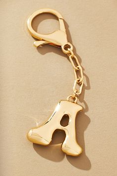 a gold keychain shaped like the letter j