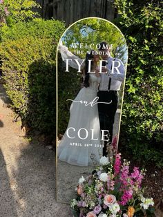 a bride and groom standing in front of a mirror with the words tyler and cole on it