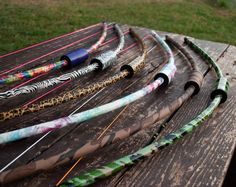 several different types of arrows are arranged on a picnic table in front of some grass