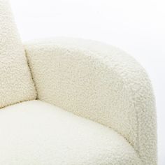 a white chair with two pillows on it's back and one seat upholstered