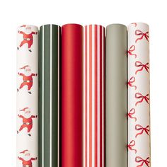 four wrapping paper rolls with christmas designs on them, all lined up in a row