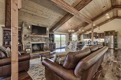 a living room filled with furniture and a flat screen tv mounted to the wall next to a fire place