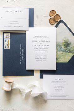 the wedding stationery is laid out on top of each other