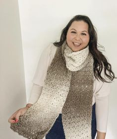 a woman is smiling and wearing a scarf with sequins on the edges,