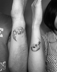 two people with matching tattoos on their arms