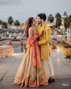 a man and woman standing next to each other on a pier