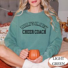 The perfect gift for the cheer coaches in your life! Football and basketball are in season and your cheer coach needs a nice warm sweatshirt for those crisp fall nights Luxurious comfort and style are what this unisex, garment-dyed sweatshirt is all about. It's made with 80% ring-spun cotton and 20% polyester and the fabric is 3-end garment-dyed, ring-spun, color-blast fleece with a 100% cotton face. Each sweatshirt comes with a relaxed fit, a rolled-forward shoulder, and a back neck patch.  .: 80% ring-spun cotton, 20% polyester .: Medium-heavy fabric (9.5 oz /yd² (322.1 g/m .: Relaxed fit .: Sewn in twill label Cheer Coach Shirts, Cheer Coach Gifts, Cheer Leading, Coach Shirt, Cheer Coach, Coach Shirts, Fall Nights, Cheer Coaches, Dyed Sweatshirt