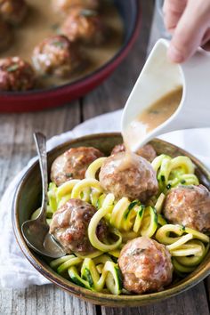 a bowl filled with meatballs and noodles