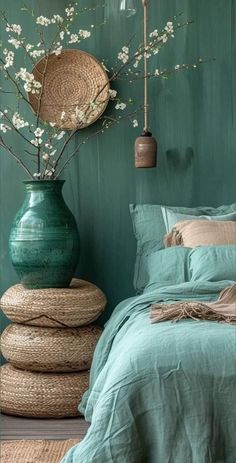 a bed room with a neatly made bed and vases on the wall next to it