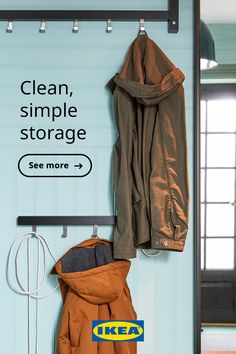 a coat hanging on the wall next to a sign that says clean, simple storage see more