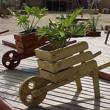 a wooden wagon with plants in it on a deck