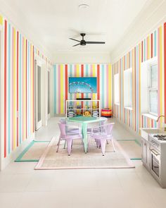 a dining room with colorful striped walls and white flooring is featured in this image