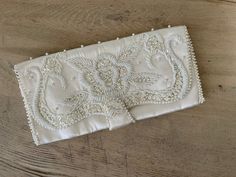 This Vintage Pearl Beaded Ivory Clutch is in great shape. Approximately 9.5X4.5in. Perfect for bridal accents or any formal evening. Elegant Embroidered Wedding Bridal Accessories, Elegant Embroidered Bridal Accessories For Wedding, Embellished White Bridal Accessories For Formal Events, Embellished White Bridal Accessories For Formal Occasions, Elegant Bridal Accessories With Pearl Embroidery For Ceremony, White Embellished Bridal Accessories For Formal Events, White Embellished Bridal Accessories For Formal Occasion, Elegant Embellished Bridal Accessories For Ceremony, Elegant Evening Bridal Accessories With Pearls