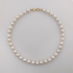 Featuring a high quality White South Sea pearl necklace, this piece secures with a 14K yellow gold interlocking oval clasp. The enticing 100% natural color - a pure white with a gentle hint of pink overtone. Pearls' size ranges from 10.3 to 11.6 mm, and are round or near round in shape. You'll be captivated by their high luster. The surface of the pearls is 85-90% clean, presenting only a few natural blemishes. These small imperfections, or nature's kisses, serve as undeniable evidence of their South Sea Pearl Necklace, Pearl Clasp, Sea Pearl, South Seas, South Sea Pearls, Saved Items, Pearl Size, Pure White, Natural Color