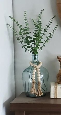 there is a vase with flowers on the shelf next to a clock and some books