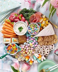 a platter filled with lots of different types of food and candy on top of a table