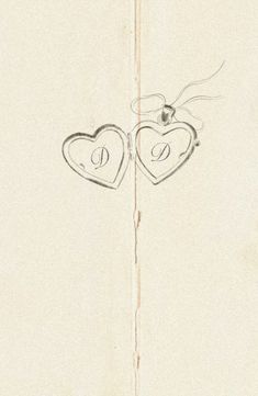 two hearts are drawn on the side of a piece of paper