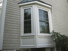 a white window on the side of a house