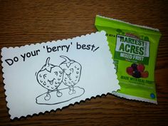 two bags of fruit sitting on top of a wooden table next to paper with writing