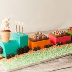 a cake shaped like a train with candy and candies on the front, sitting on a table