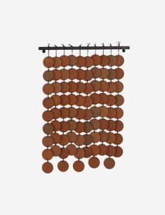 a wall hanging made out of brown circles