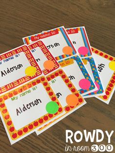 four different printable name tags on a wooden table