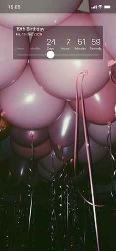 a bunch of balloons that are in the air with numbers on them and one balloon attached to it