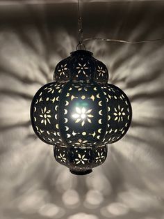 an intricately designed lamp hanging from the ceiling