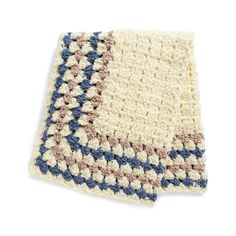 a crocheted rug with blue, beige and white squares on the bottom side