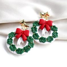 pair of christmas wreath earrings on white fabric