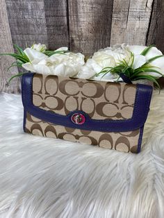 a coach purse with white flowers in it