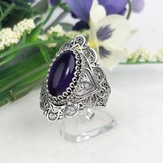 925 Sterling Silver Genuine Natural Purple Amethyst Handmade Artisan Crafted Filigree Statement Ring Material: 925 Solid Sterling Silver, 925 Stamped Genuine Amethyst Gemstone Dimensions : 14 mm x 7 mm, Oval, Cabochon, Approximate Total Carat Weight: 3.4 Ring Face Length: 1.10 inches Ring Face width: 0.45 inches Finishing: Oxidized & Polished This will come in a designer pouch & gift box Free Domestic Shipping Our fine silver jewelry is made in our exclusive Artisan workshops in Turkey. Our aim Red Crystal Ring, Key Drawings, Onyx Rings, Purple Queen, Nose Ring Jewelry, Pearl Rings Vintage, Goth Accessories, Vintage Gold Rings, Sterling Silver Cat