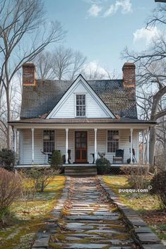 a white house with stone steps leading to the front door