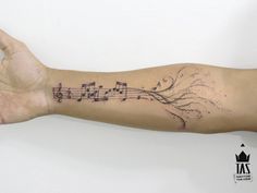 a person's arm with musical notes on it