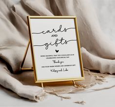 a wedding card and gift sign sitting on top of a bed next to a blanket