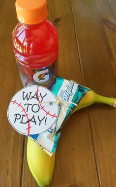 a bottle of water and a banana sitting on a table with a sign that says way to play