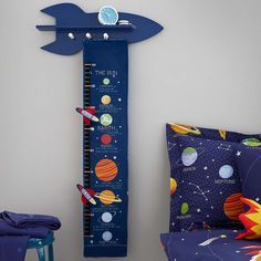 a child's room with a space theme growth chart