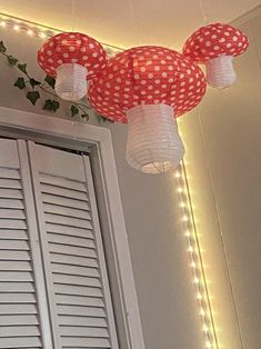 red and white paper lanterns hanging from the ceiling